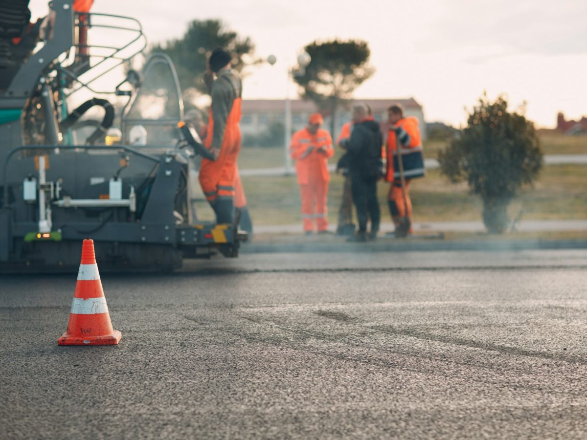 Asphalt paving. Paver machine and workers. New road construction.